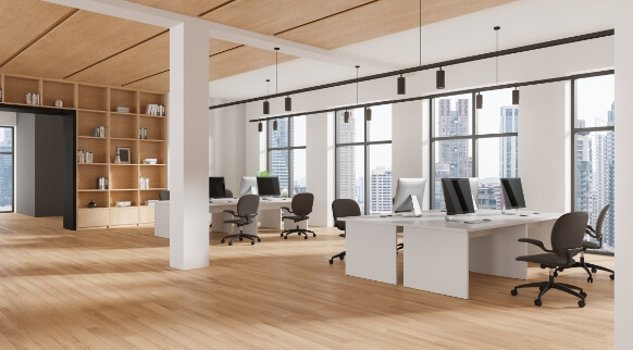 Modern office space with natural hardwood flooring and workstations