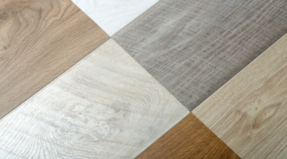 Variety of hardwood flooring planks showing different colors and grain styles